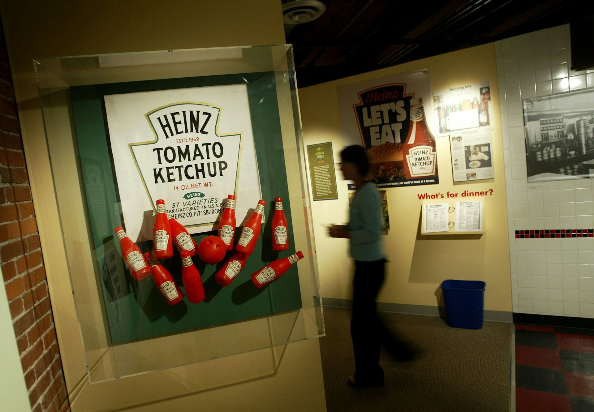 A woman walks through an exhibit showing the history of the Heinz corporation at the U.S. Senator John Heinz Pittsburgh Regional History Center 